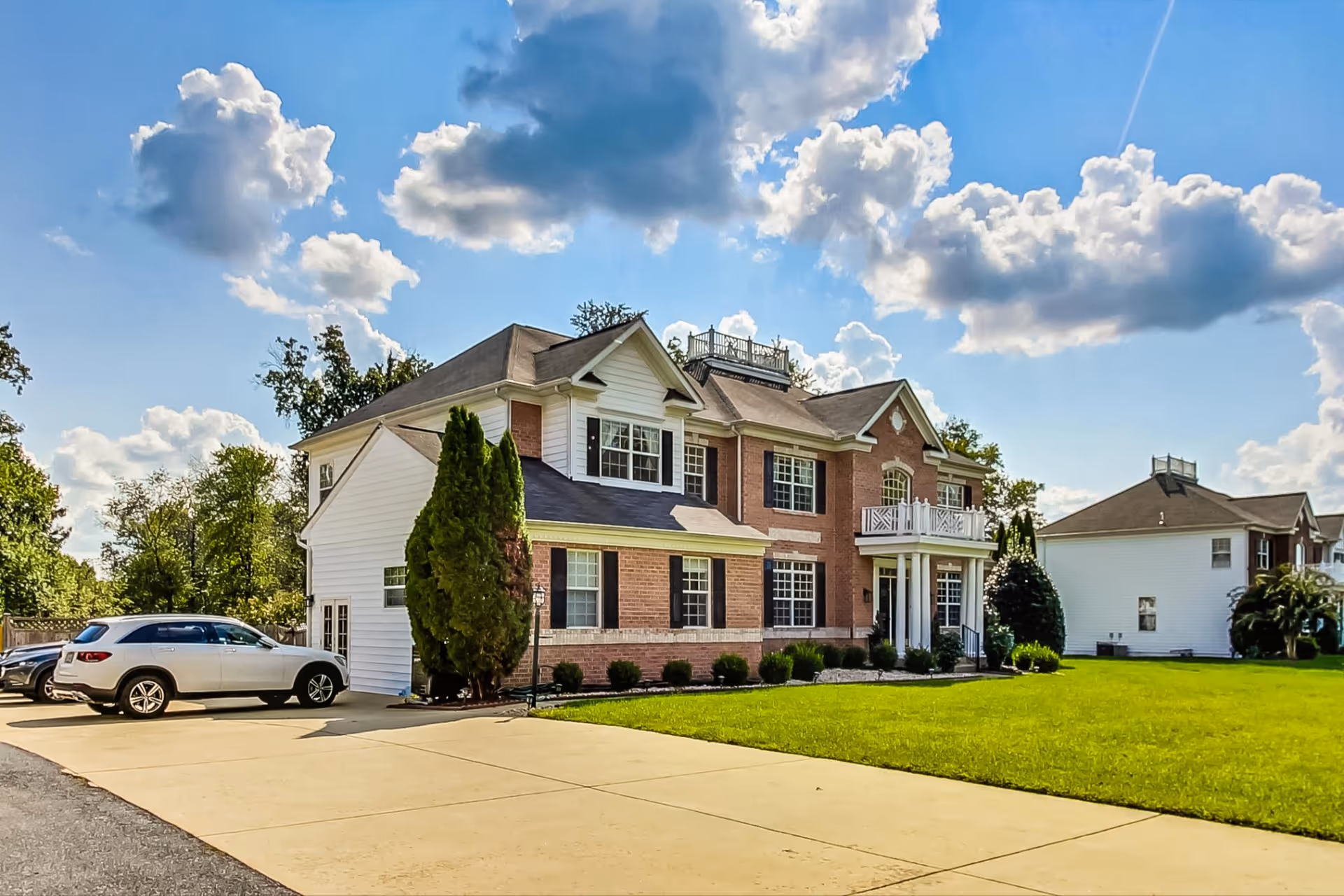 Laytonsville Estate Assisted Living building, a two-story brick-and-white exterior with a manicured lawn.