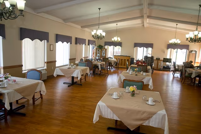 The Lyons Health & Living Center dining room features beige tablecloths and flower centerpieces.