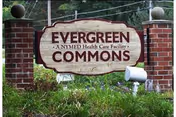 Entrance sign reads EverGreen Commons Rehabilitation and Nursing Center with brick pillars and greenery.