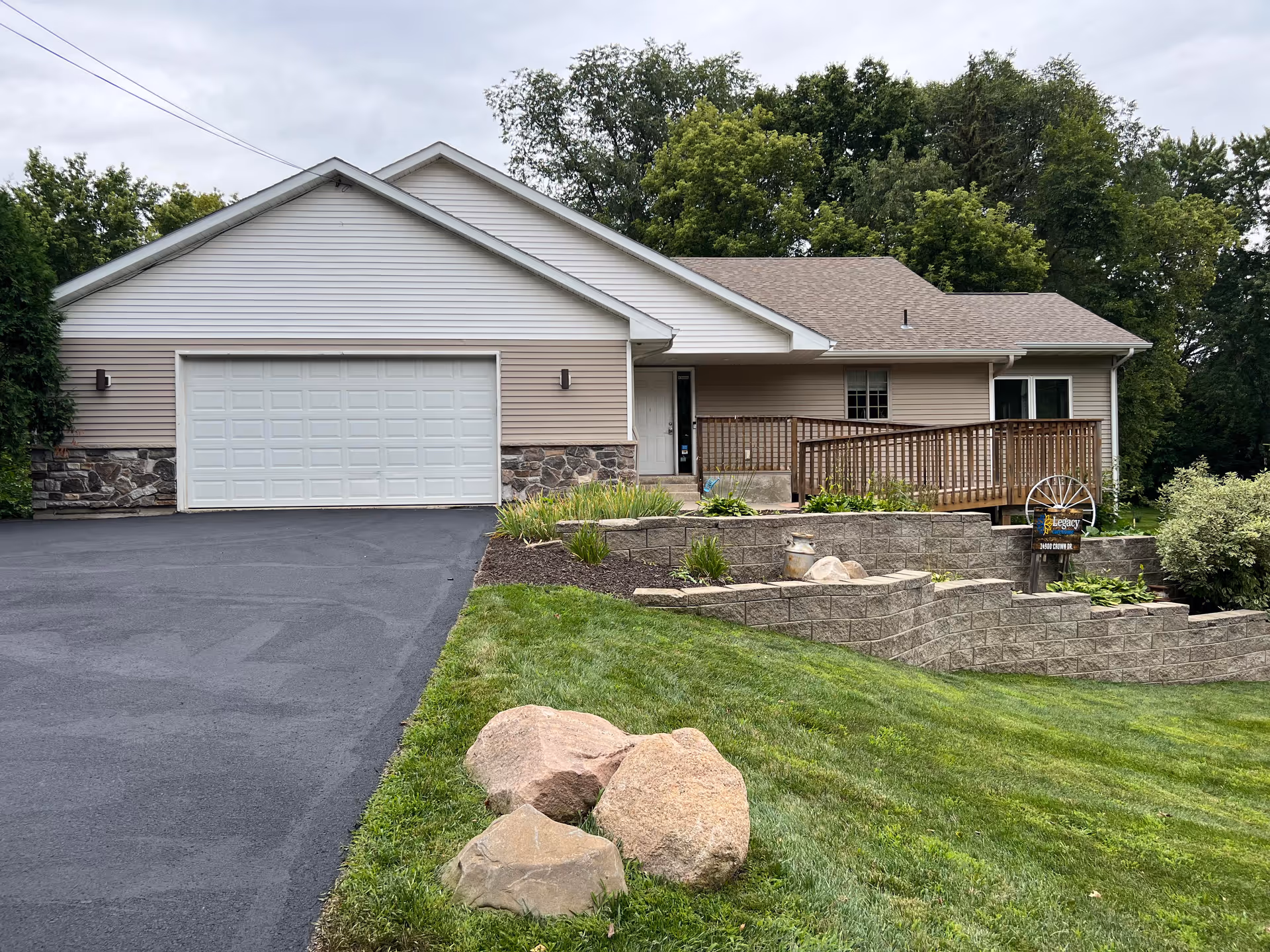 Exterior of Legacy Care Home: a single-story house with a two-car garage and landscaped front yard.