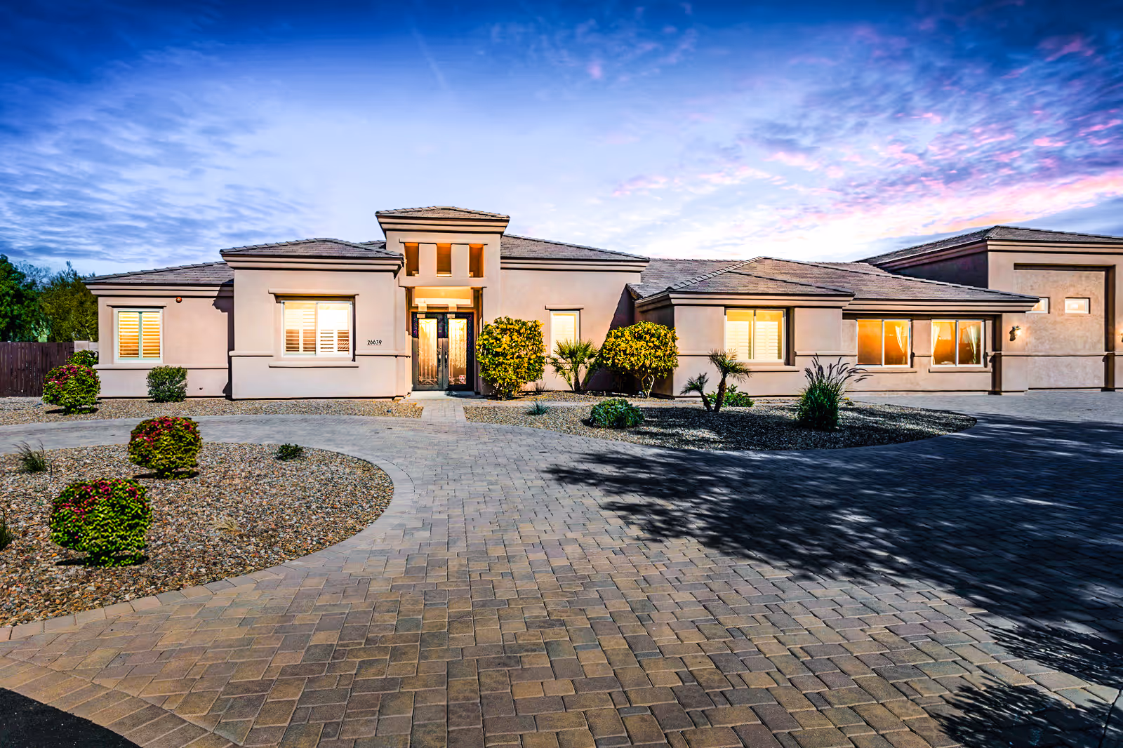 Single-story assisted living facility with curved driveway and desert landscaping.