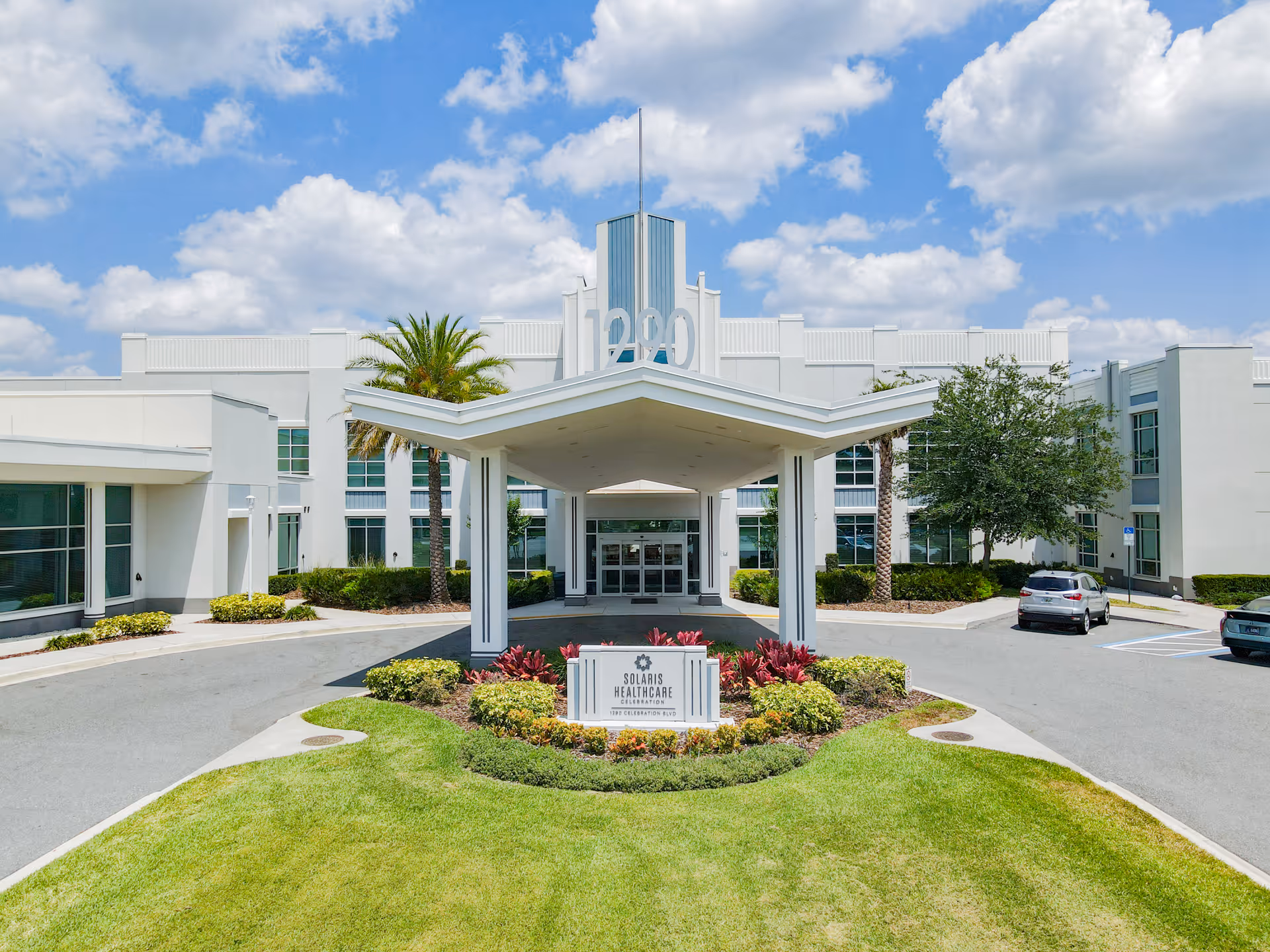 Solaris Healthcare Celebration front entrance with curved canopy and landscaped roundabout.