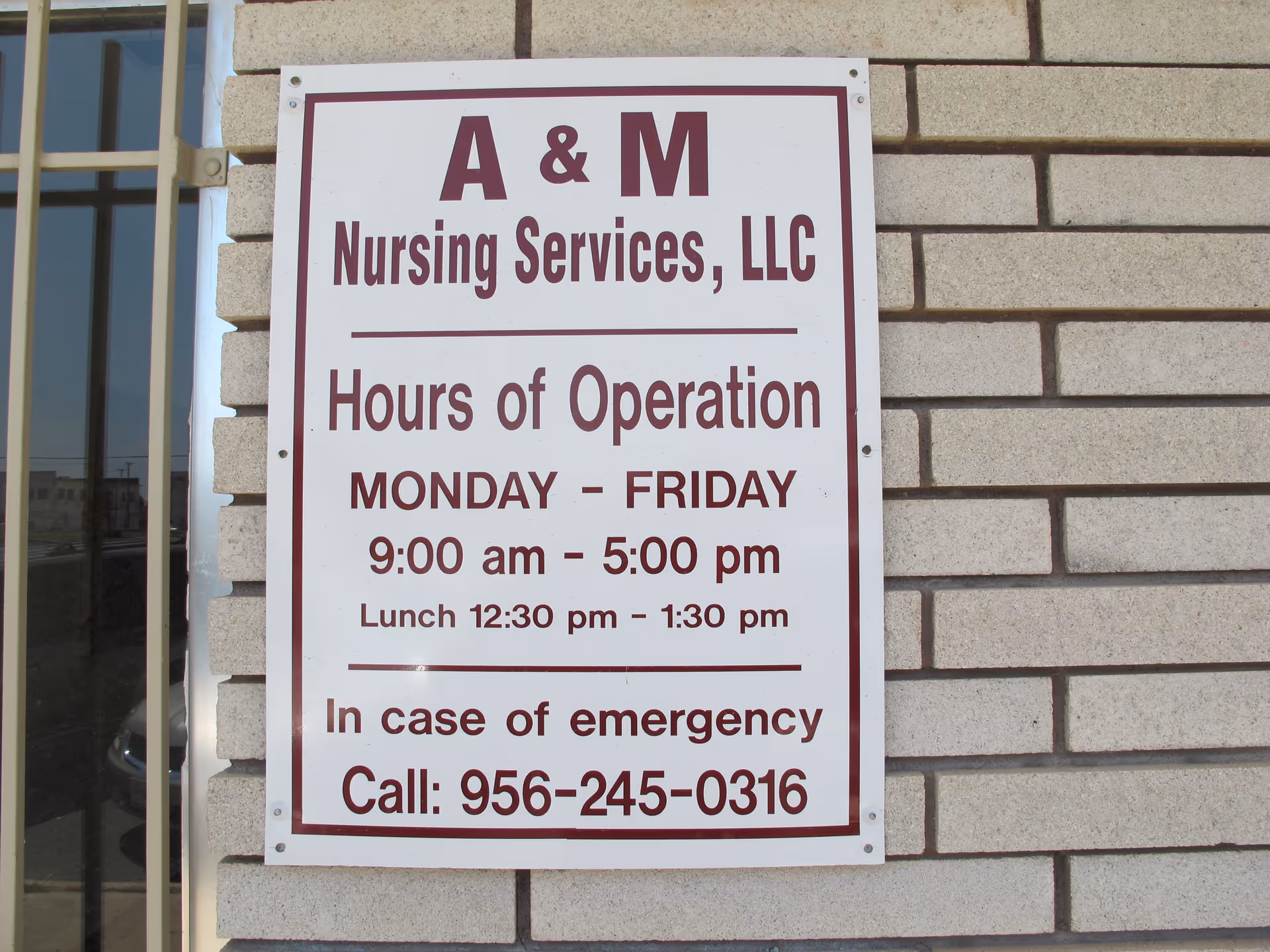 Exterior brick wall sign shows A & M Nursing Services, LLC hours of operation.