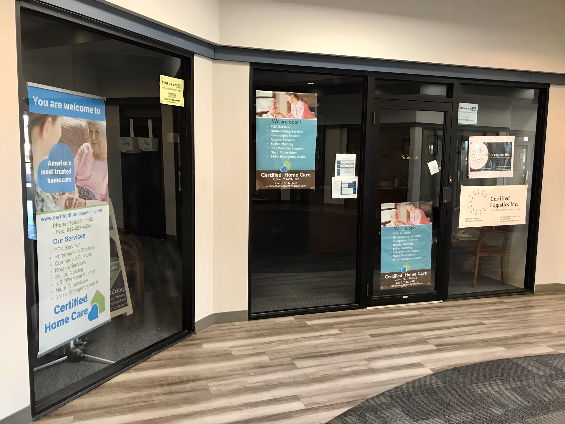 Glass entry doors with posters and signage for Certified Home Care in a corridor.