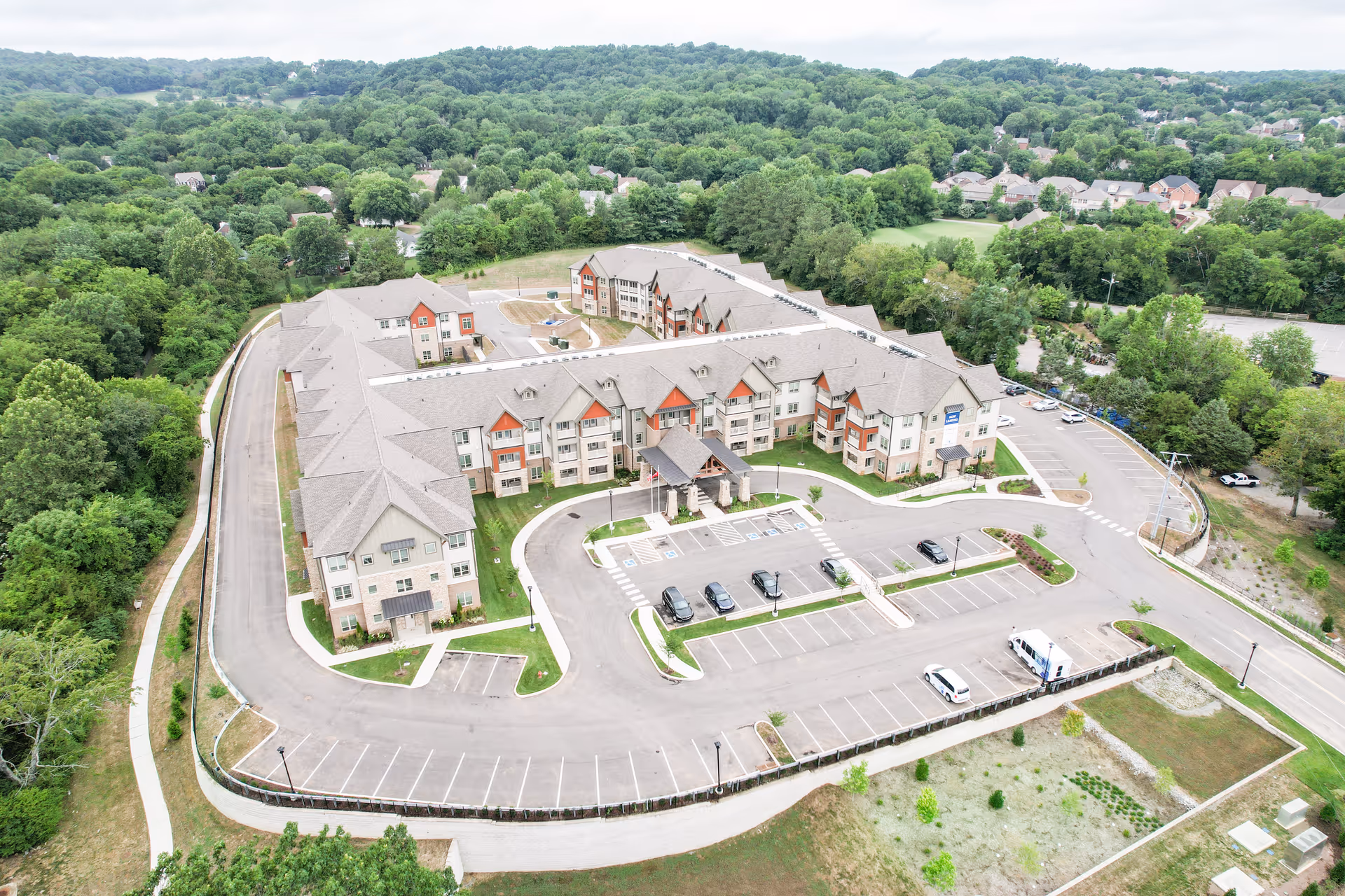 Aerial view of Harmony at Bellevue senior living campus with parking and greenery.