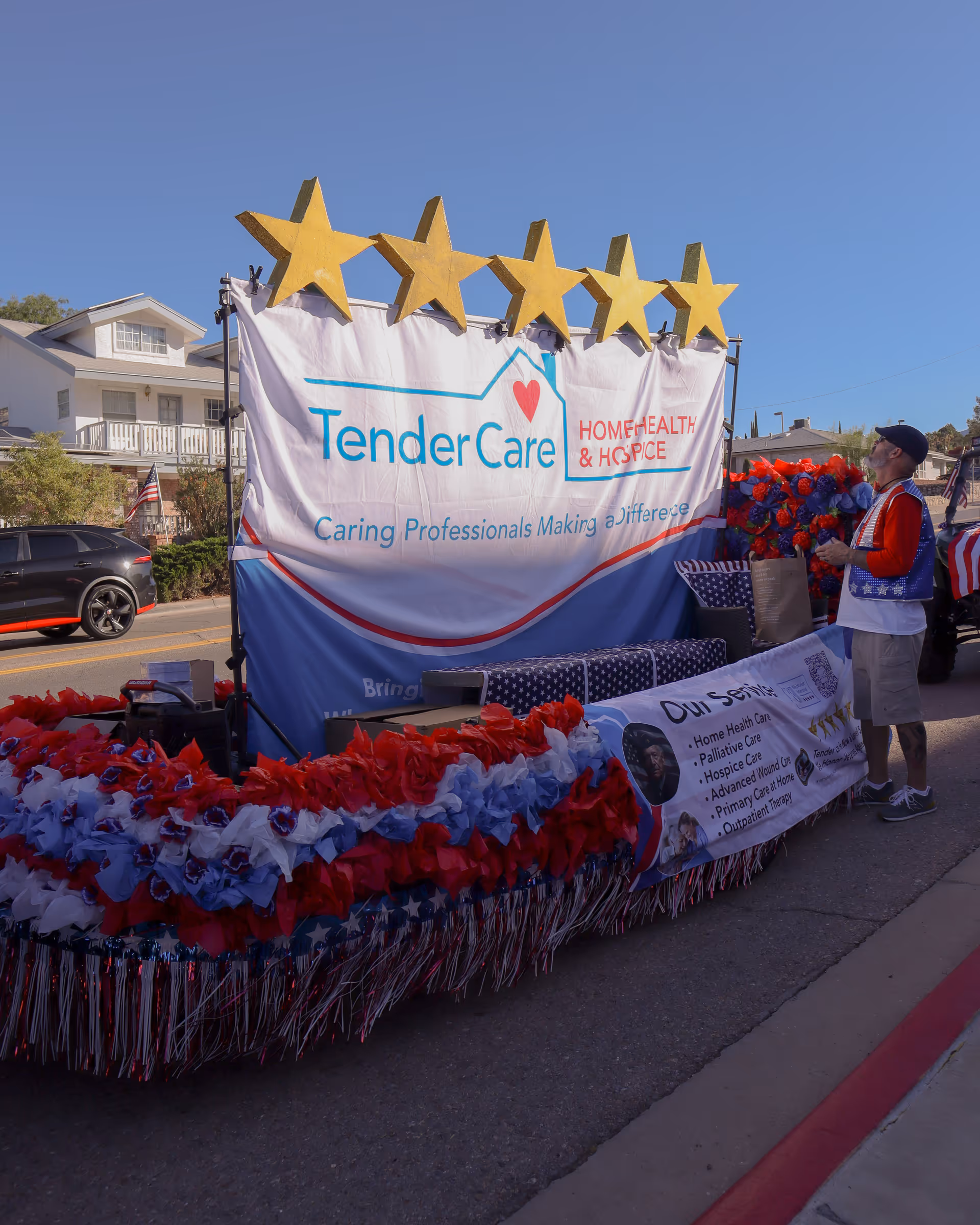 Parade float for Tender Care Home Health & Hospice on a sunny street with stars