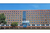 Facade of Queens Boulevard Extended Care Facility with a glass central entrance.