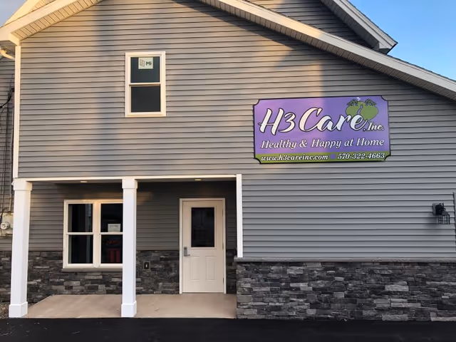 Front exterior of H3 Care, Inc. facility with purple sign and stone veneer.