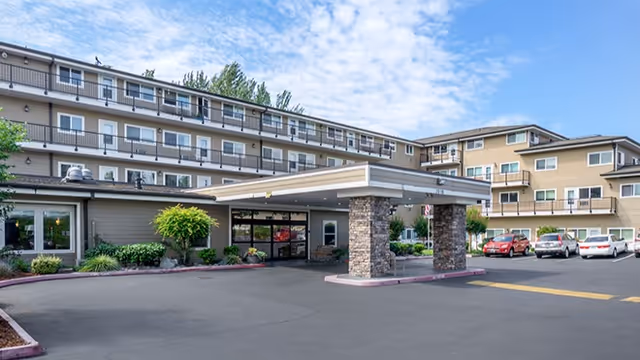 Exterior view of Brookdale Allenmore Independent Living with a covered entrance and cars