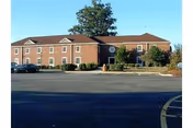 Front view of Fair Acres Geriatric Center, a brick senior housing facility with a parking lot.