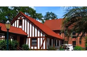 Timber-framed Tudor-style retirement community building with a red roof.