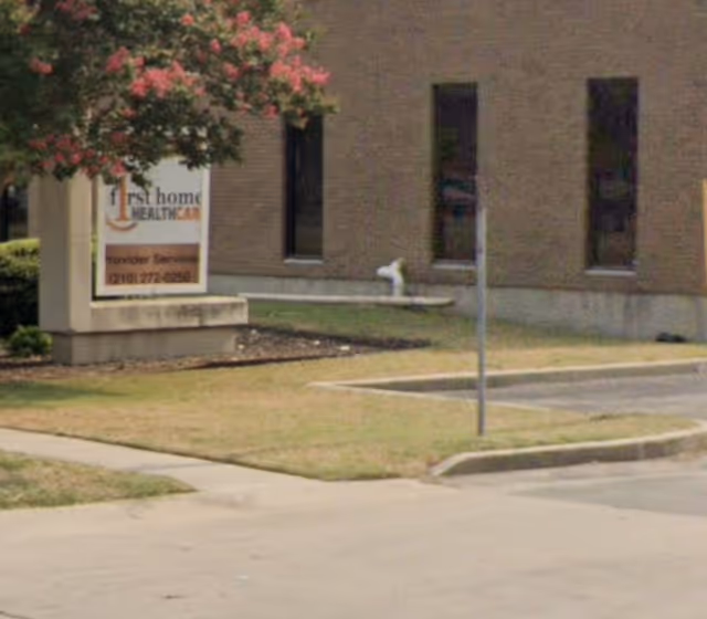Exterior view of First Home Healthcare building with sign and entrance pathway