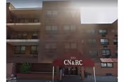 Brick exterior of Concord Nursing and Rehabilitation Center with a red awning at the entrance.
