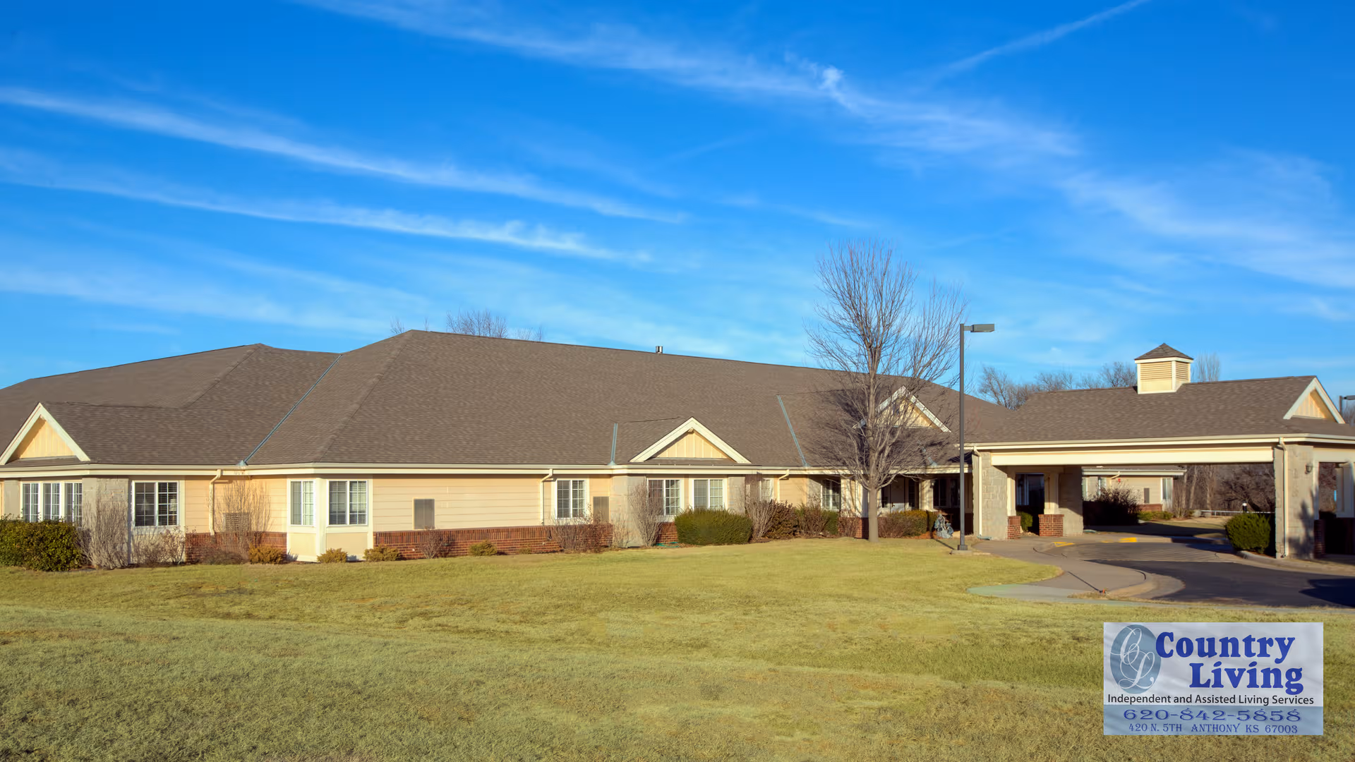 Single-story senior living facility exterior with a lawn, driveway, and Country Living sign.