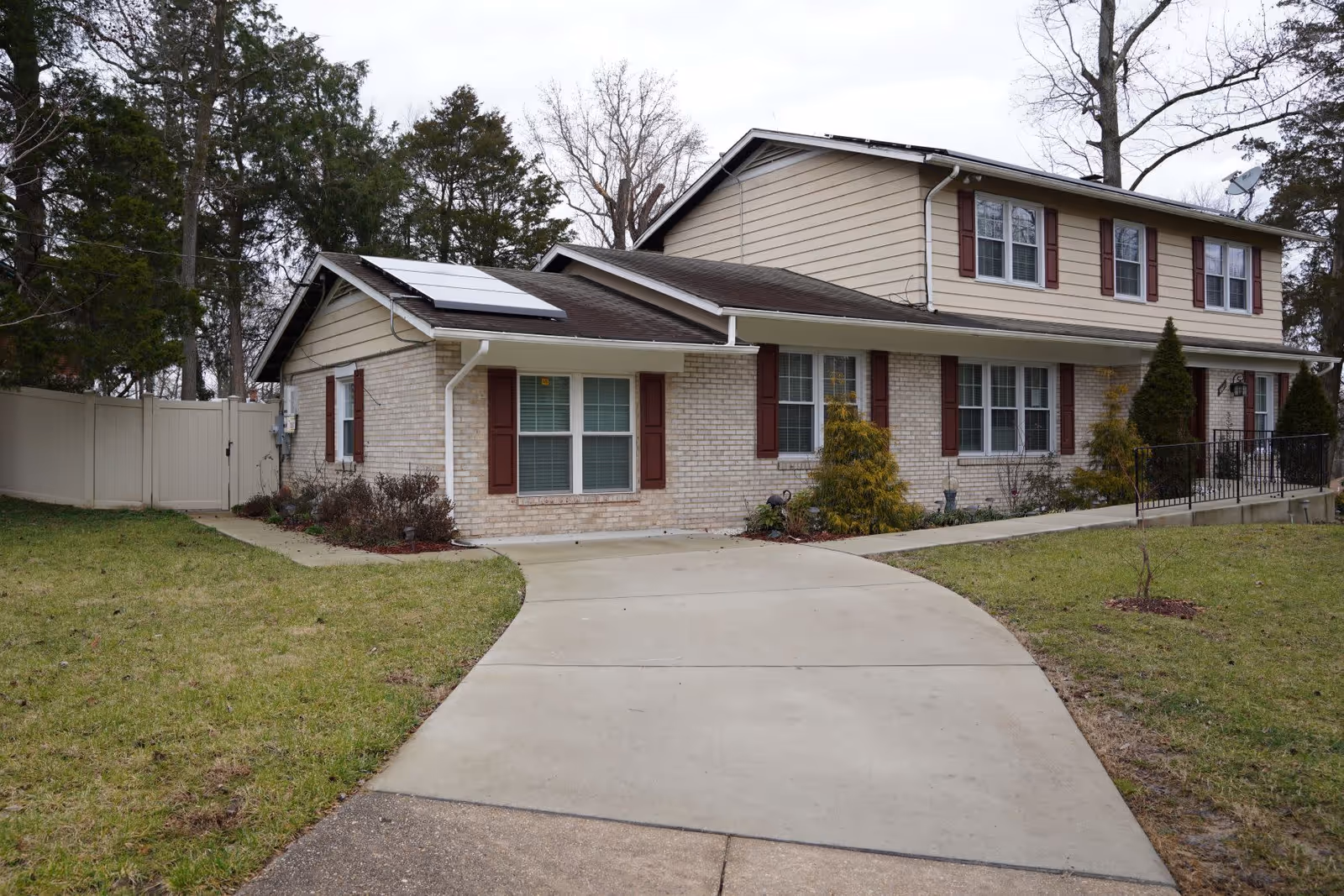 Two-story senior living building with beige brick and curved driveway