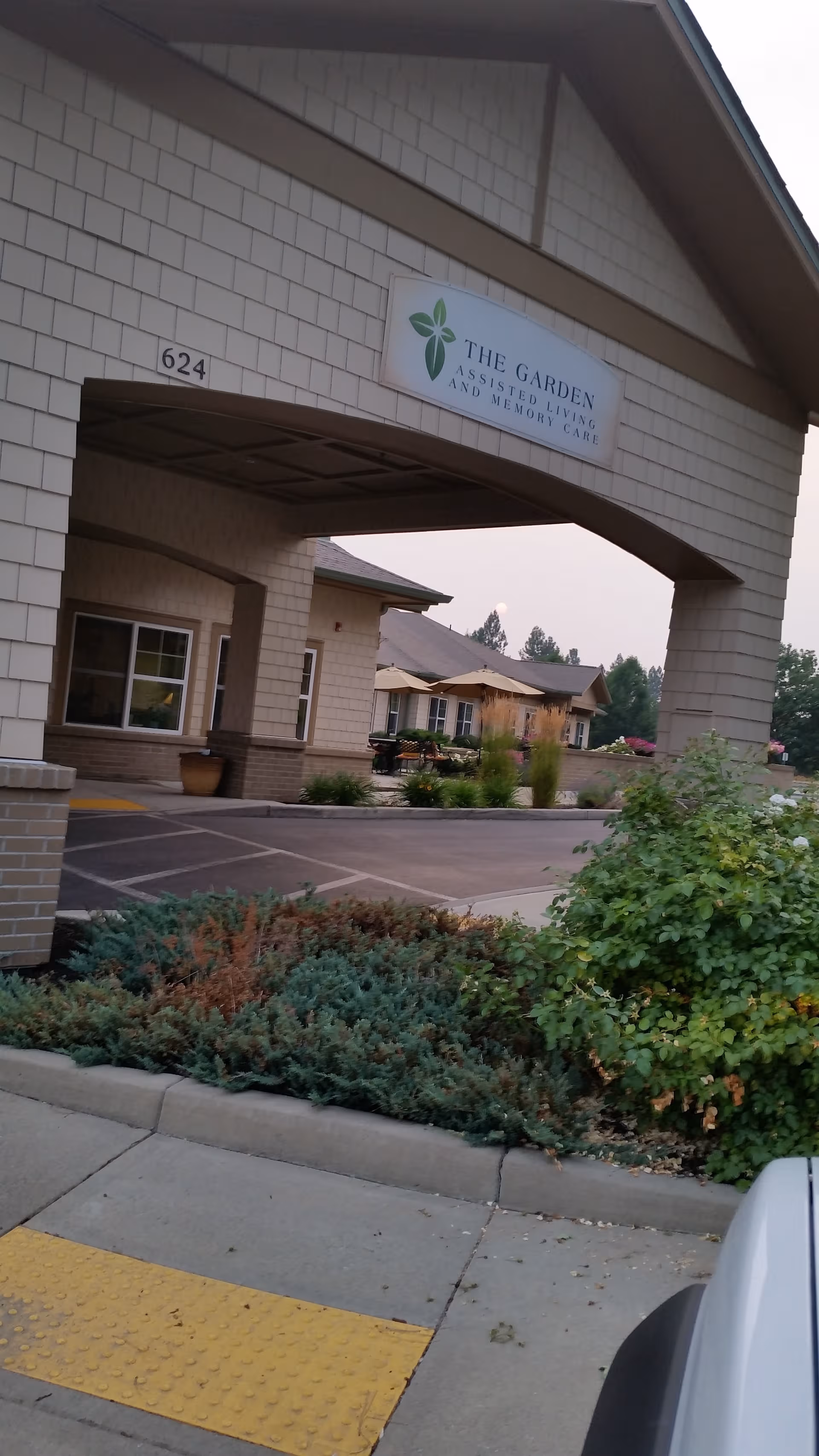 Exterior view of Orchard Ridge Senior Living entrance with canopy sign and landscaping.