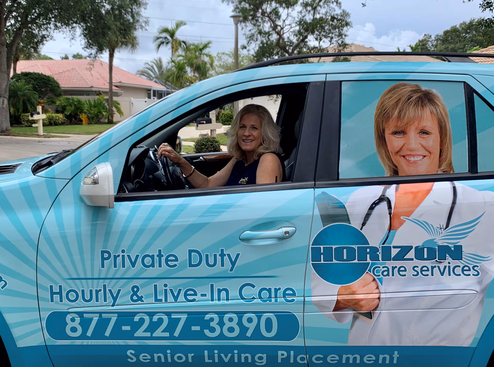 Side view of a Horizon Care Services van with two smiling people inside.