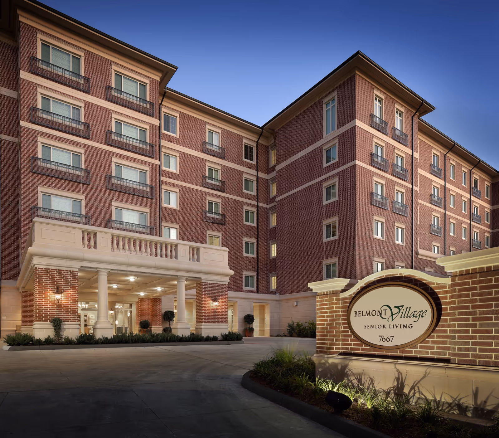 Exterior view of Belmont Village Senior Living Hunters Creek with entry plaza and sign.