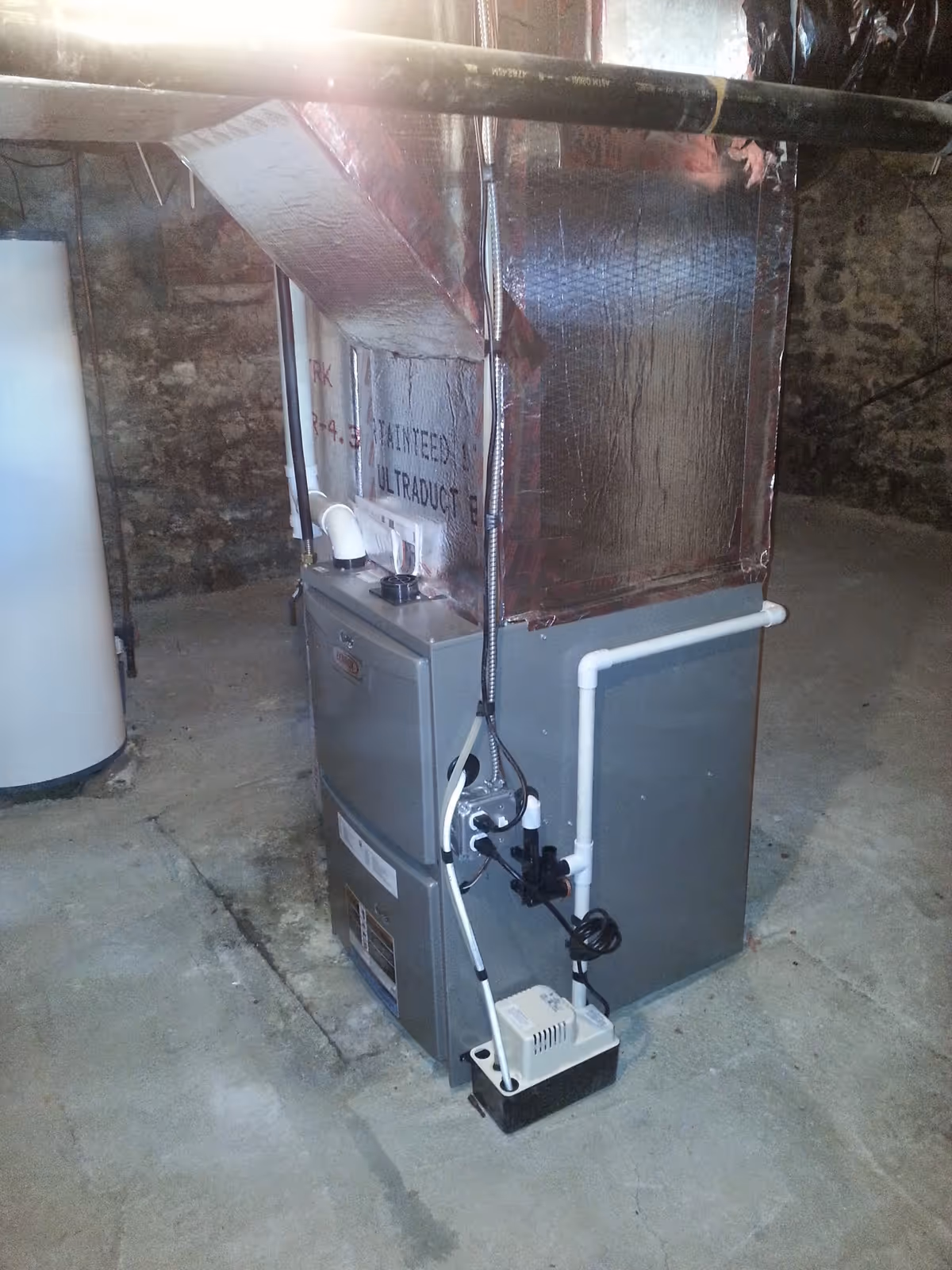 Basement view of a furnace and insulated ductwork in a mechanical area