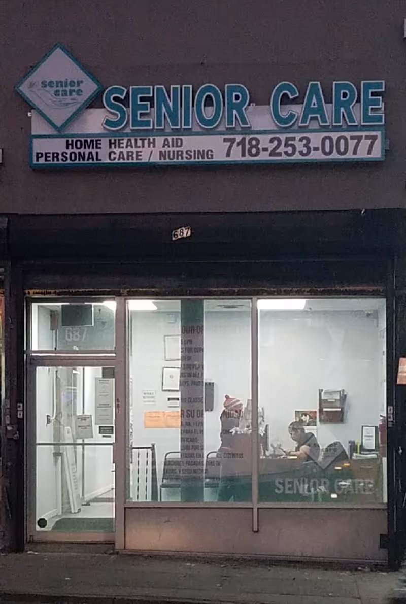Front of a Senior Care storefront with a large sign and people inside.