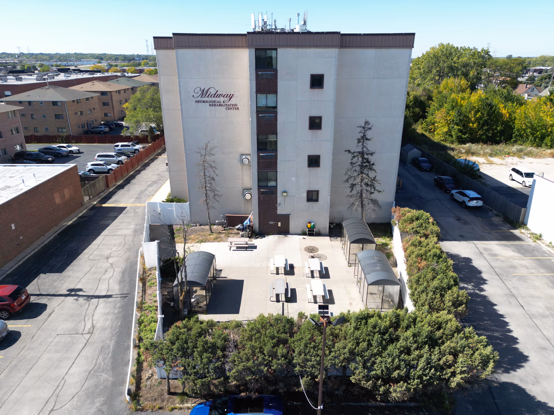 Aerial view of Midway Neurological Rehab Center building with an outdoor courtyard and seating.