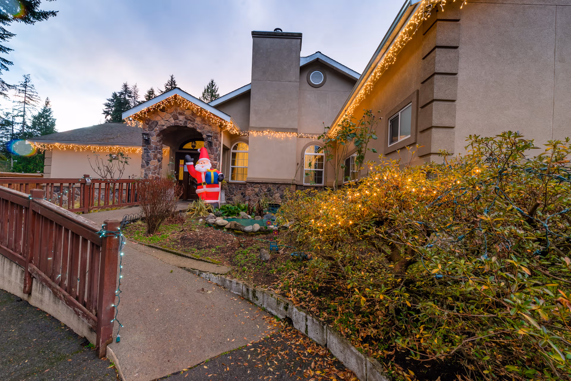 Exterior view of Pine Lake AFH front entrance with holiday lights and Santa statue