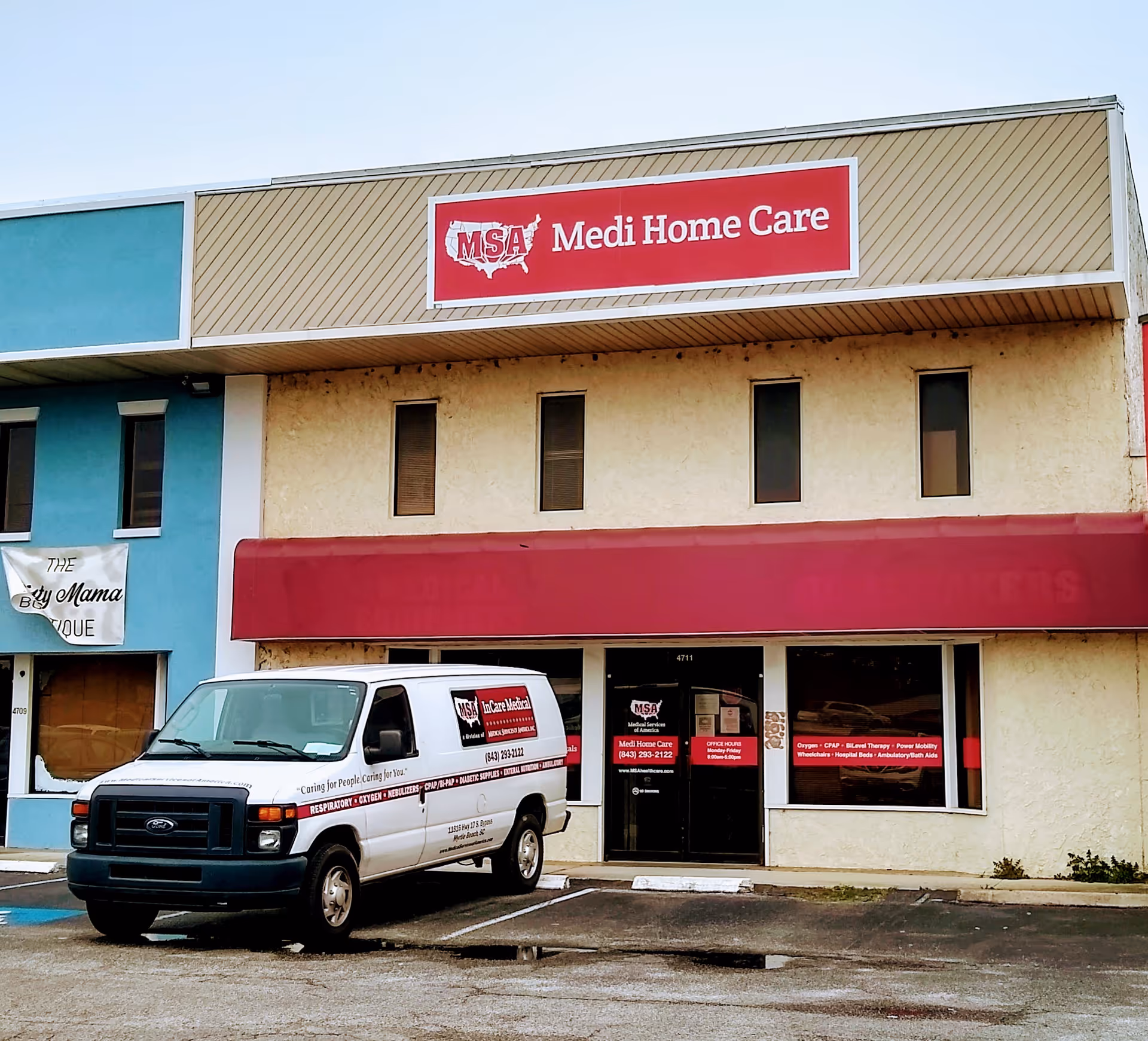 Front of a beige storefront building with a red MSA Medi Home Care sign and van.