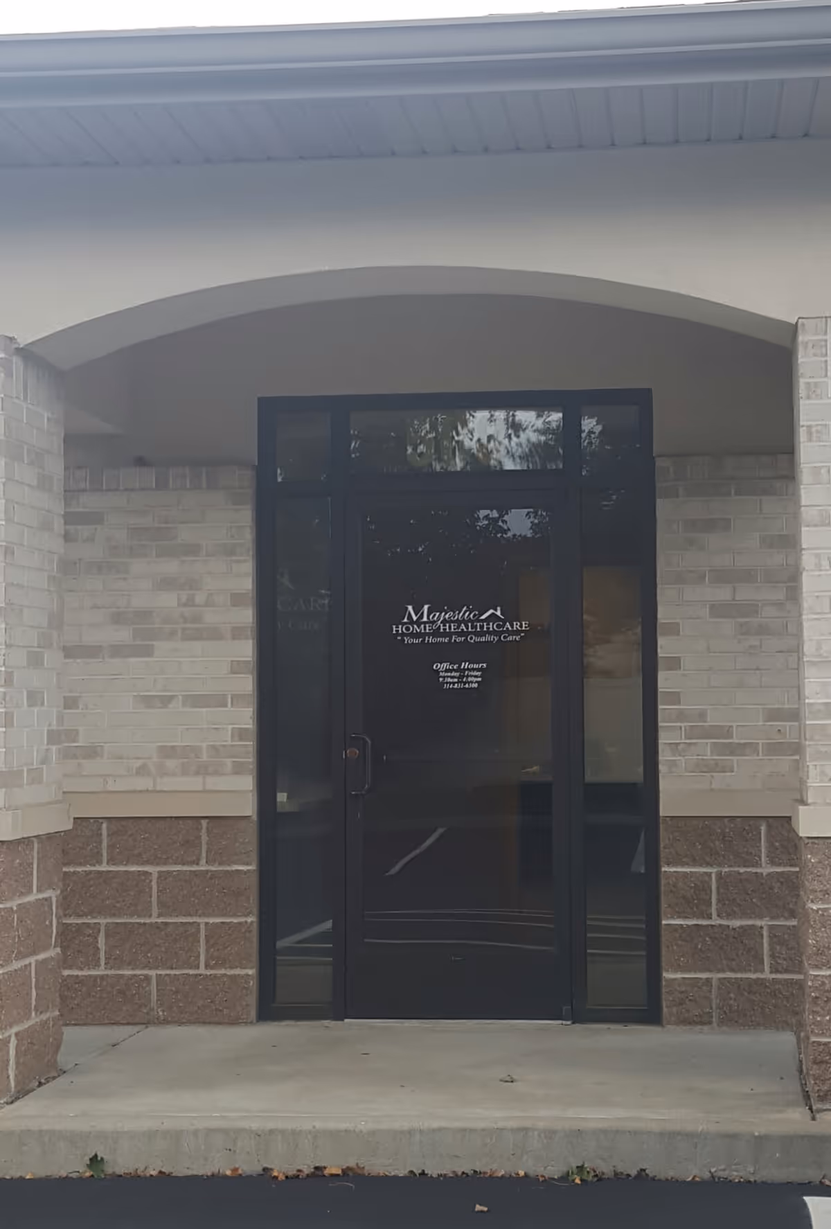 Exterior entrance of Majestic Home Healthcare with glass door and brick facade.
