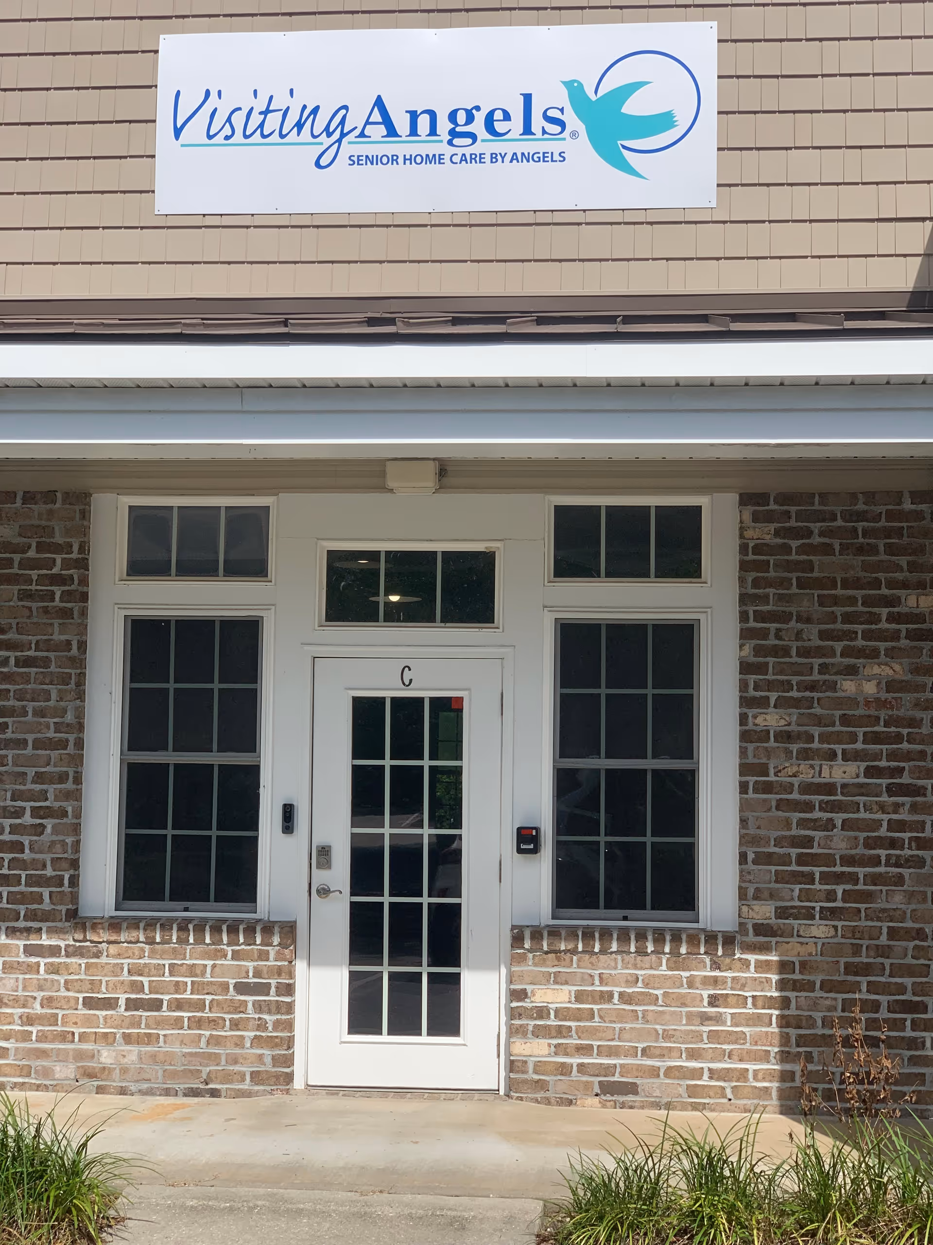Front facade of Visiting Angels Senior Home Care Southport with entrance door and sign.