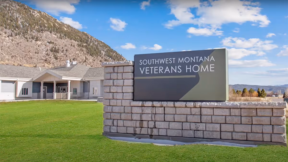 Front exterior of Southwest Montana Veterans Home with a large stone sign.