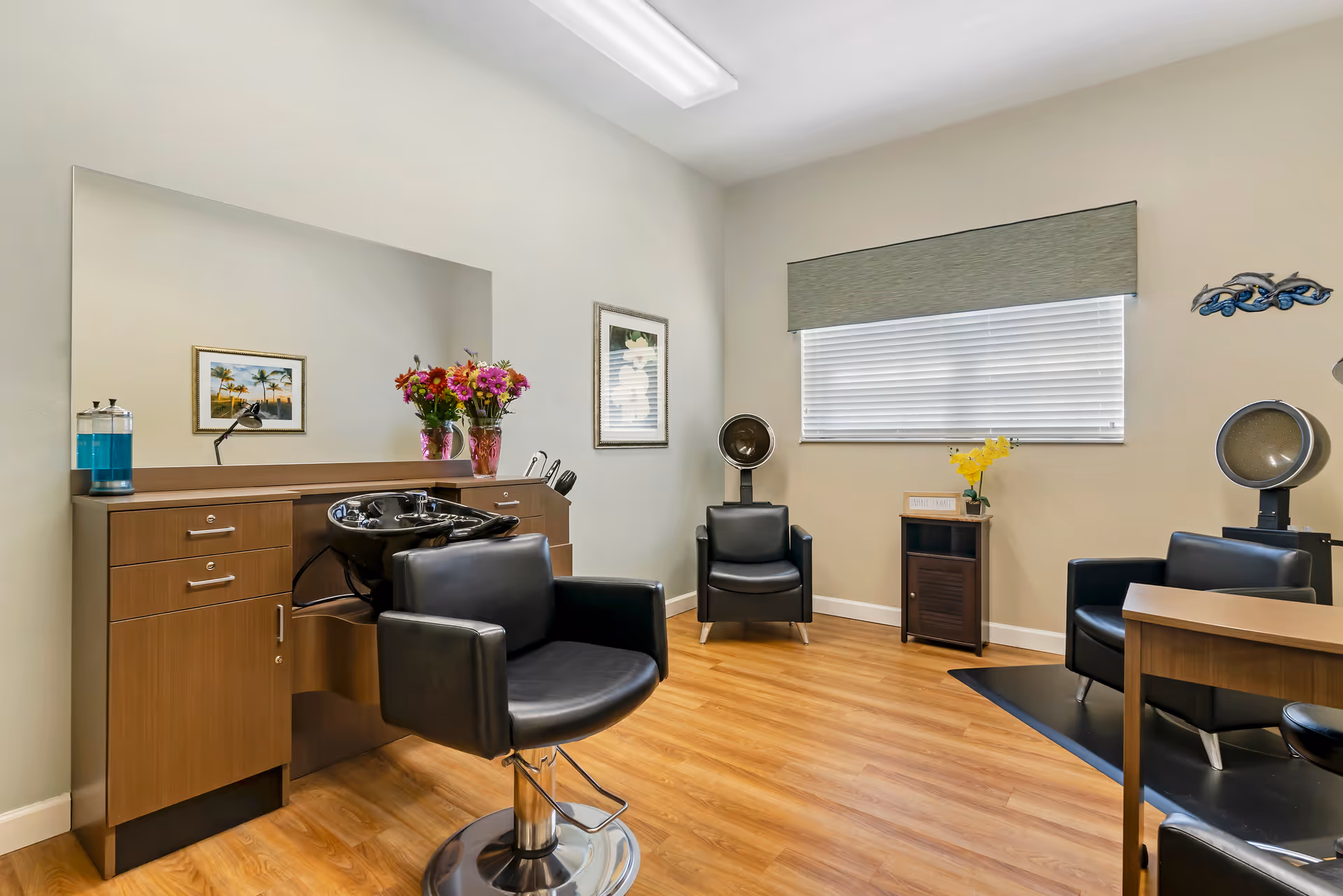 Hair salon interior with chairs, mirrors, and cabinetry in a senior living facility