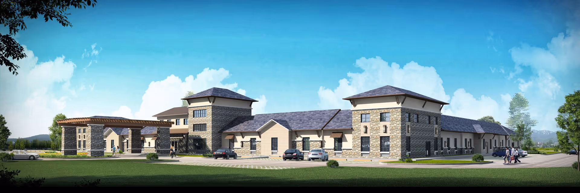 Exterior view of a large, modern senior living facility building with stone and beige siding, multiple roof levels, and a covered entrance. Several cars are parked in front, and a few people are walking near the entrance. The sky is clear with some clouds, and there is green grass and trees surrounding the building.