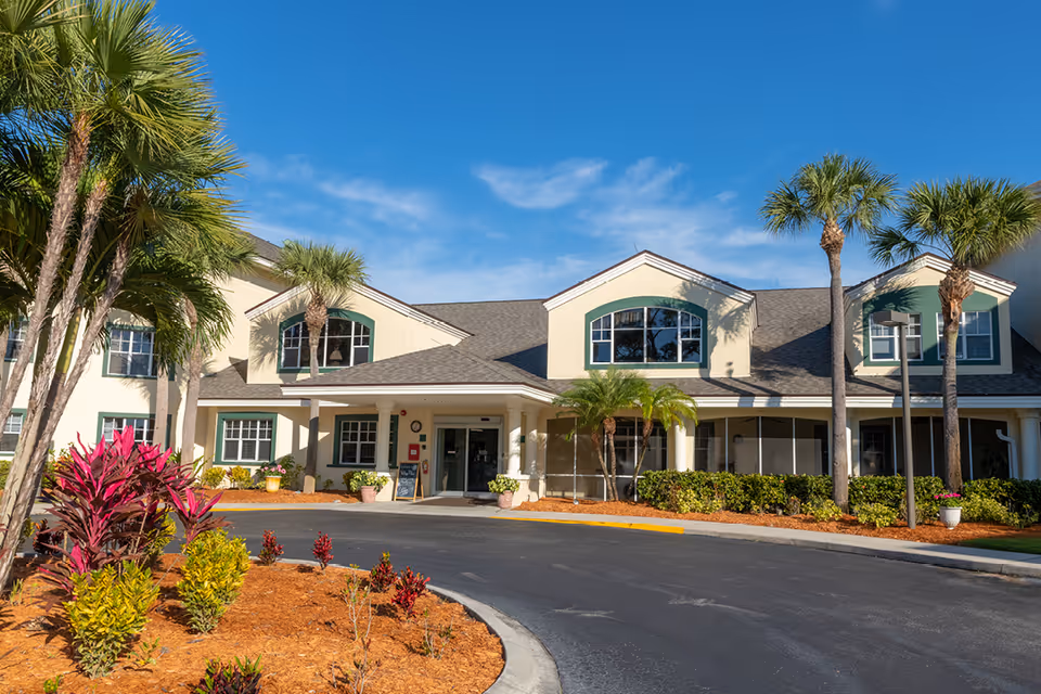 Exterior view of Truewood by Merrill Charlotte Center with palm trees and entrance