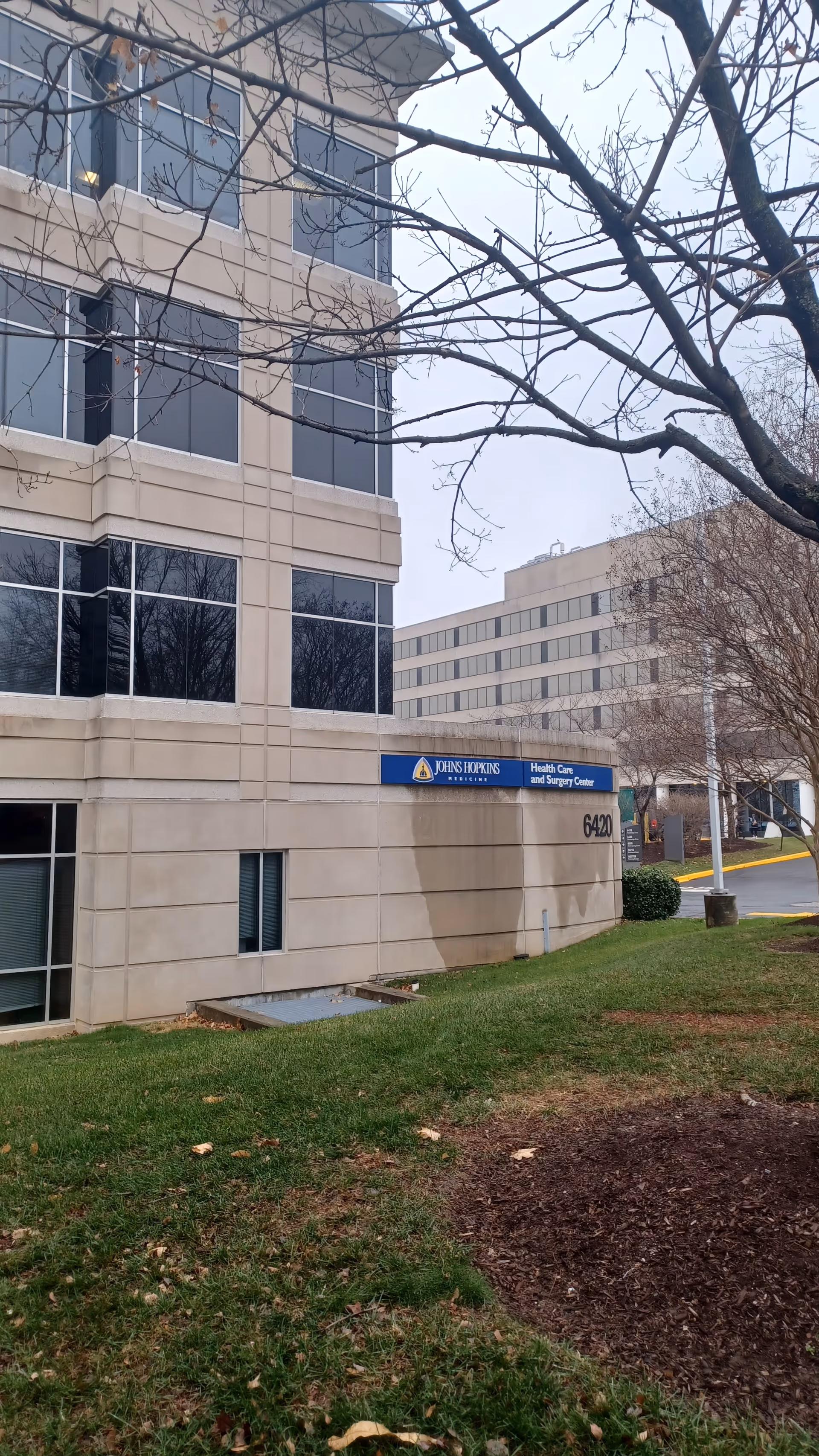 Exterior view of a Johns Hopkins Health Care and Surgery Center building with sign.