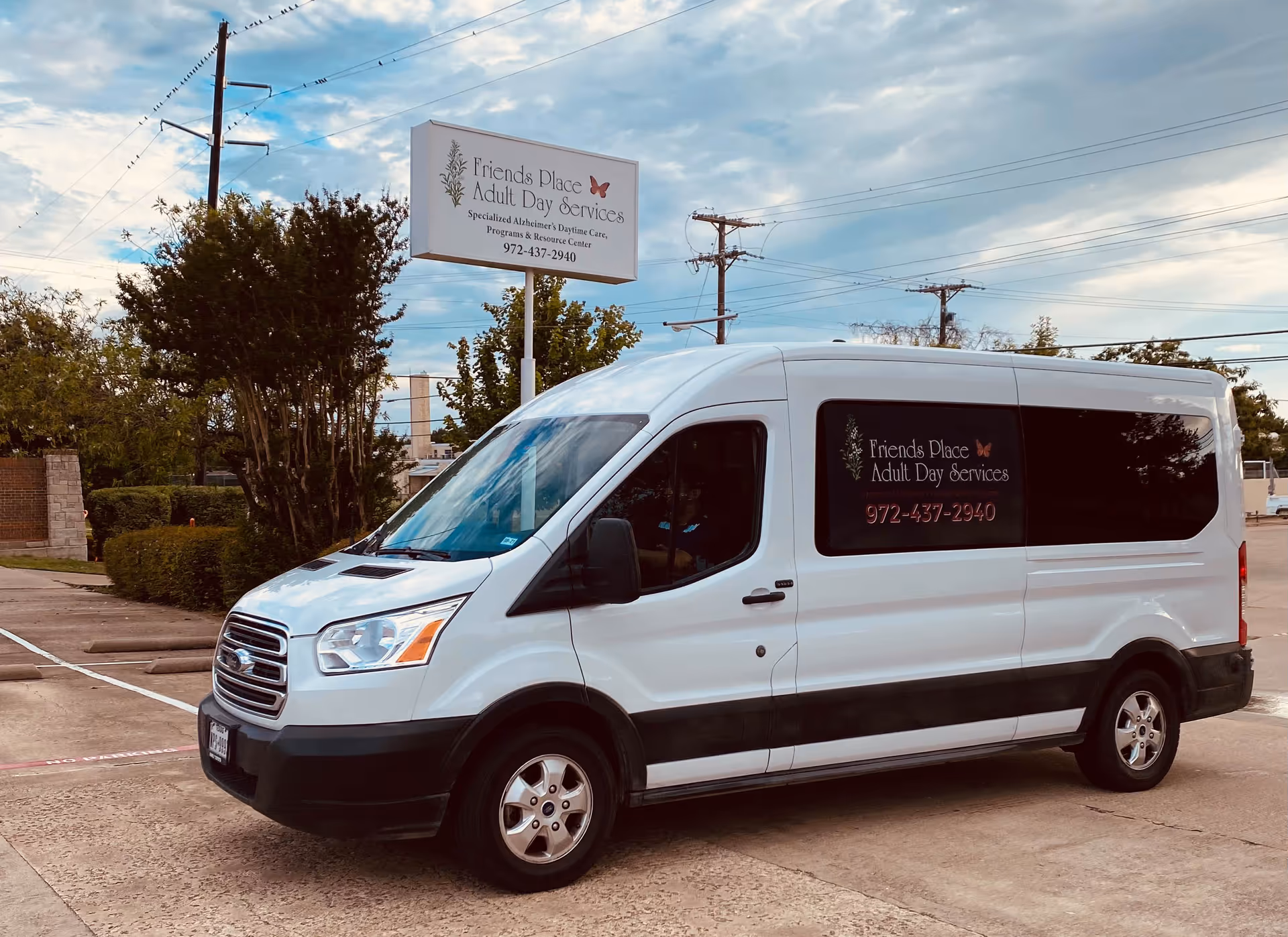 White van with Friends Place Adult Day Services logo parked near facility sign