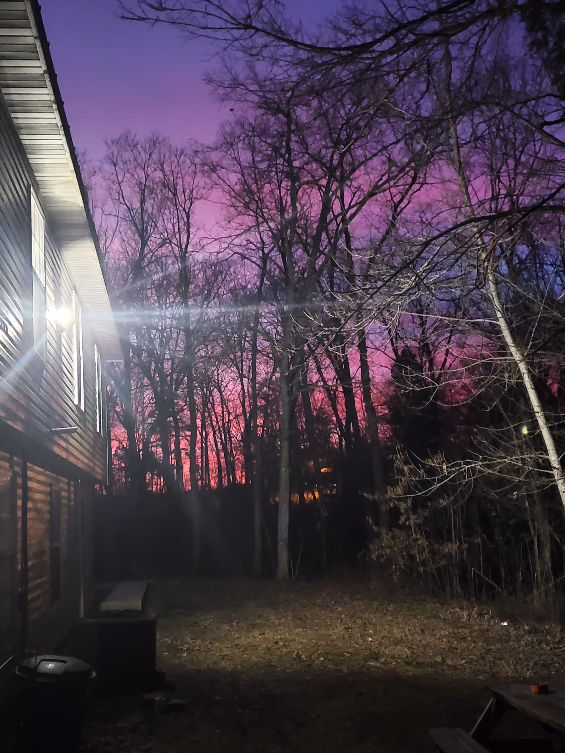 Exterior view of Hillside Living Center at dusk with purple sky and trees.