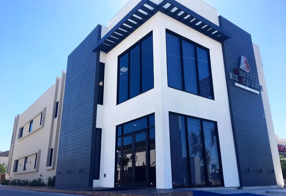 Modern two-story senior care building with large glass front and dark gray panels.
