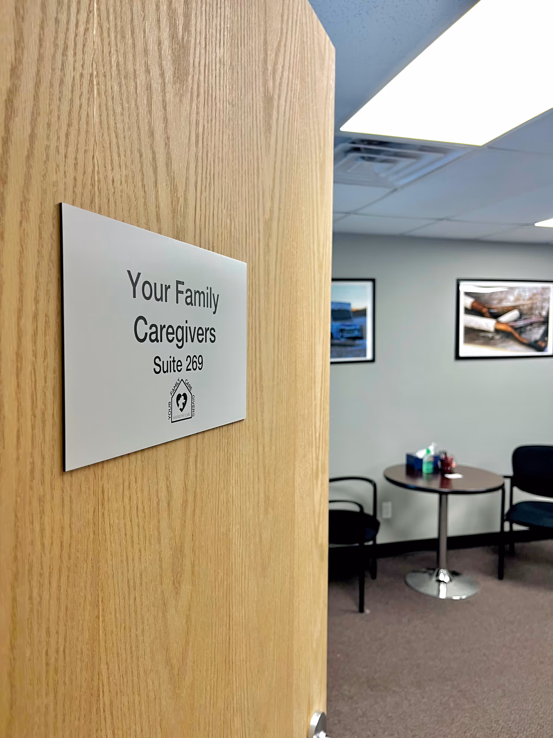 Door sign reads 'Your Family Caregivers Suite 269' with a small waiting area.