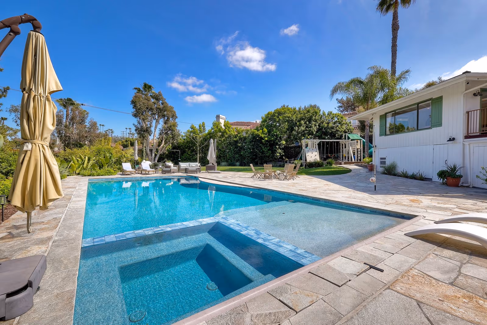 Sunny outdoor pool area at Casa La Granada with lounge chairs and patio.