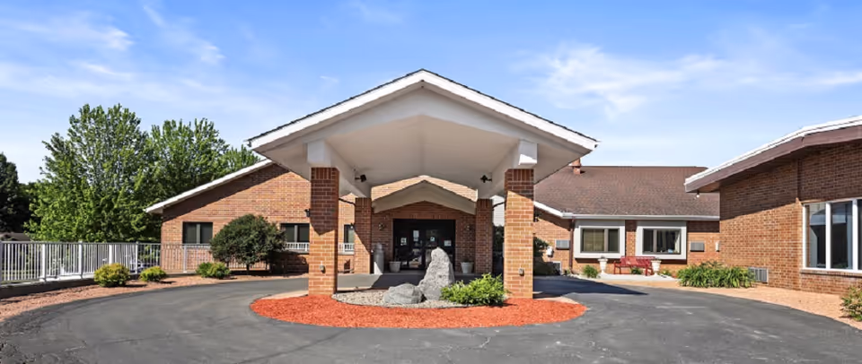 Front view of Mulberry Campus Memory Care entrance with brick building and canopy