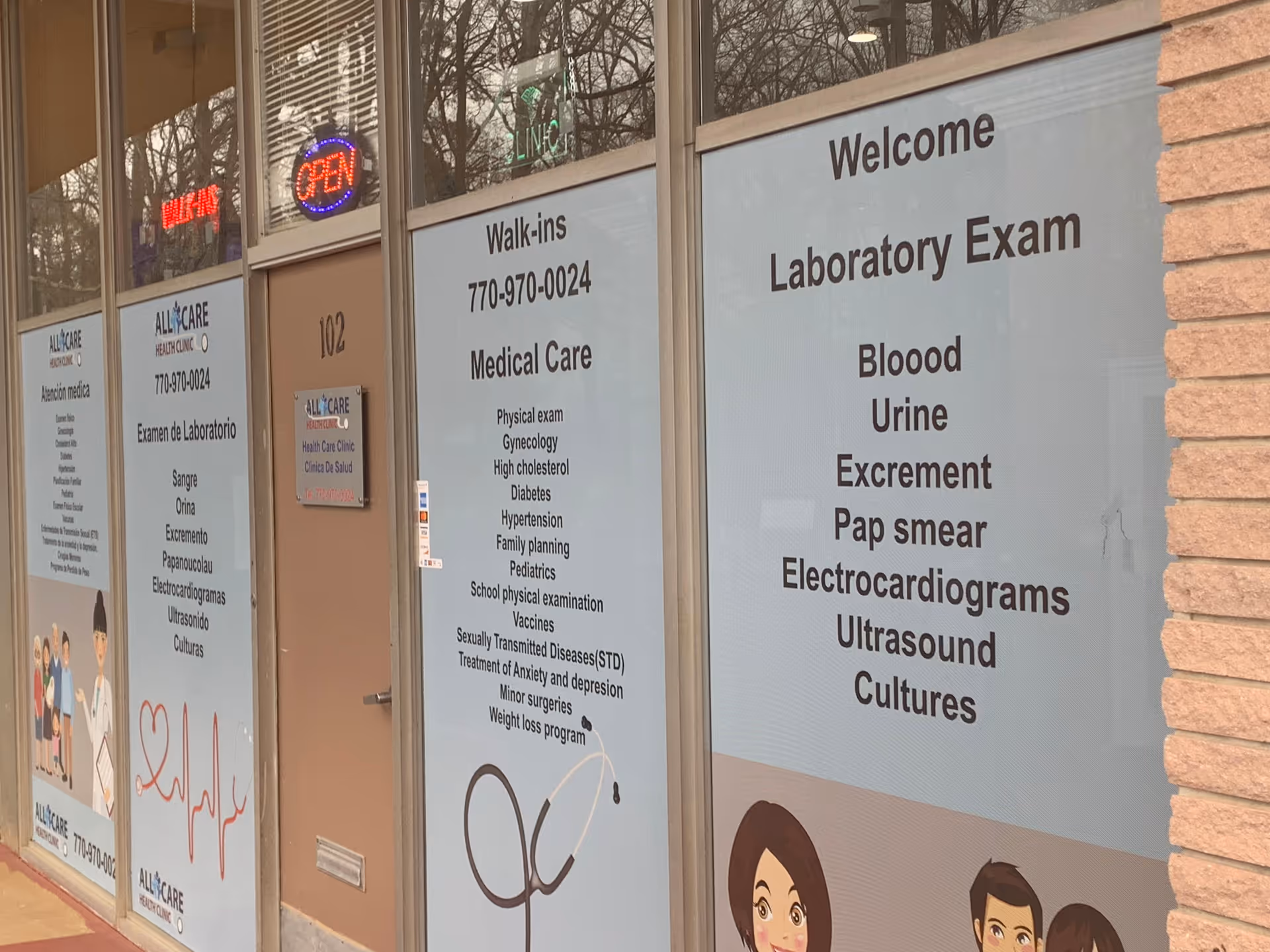 Storefront with large windows advertising walk-ins and laboratory exams.