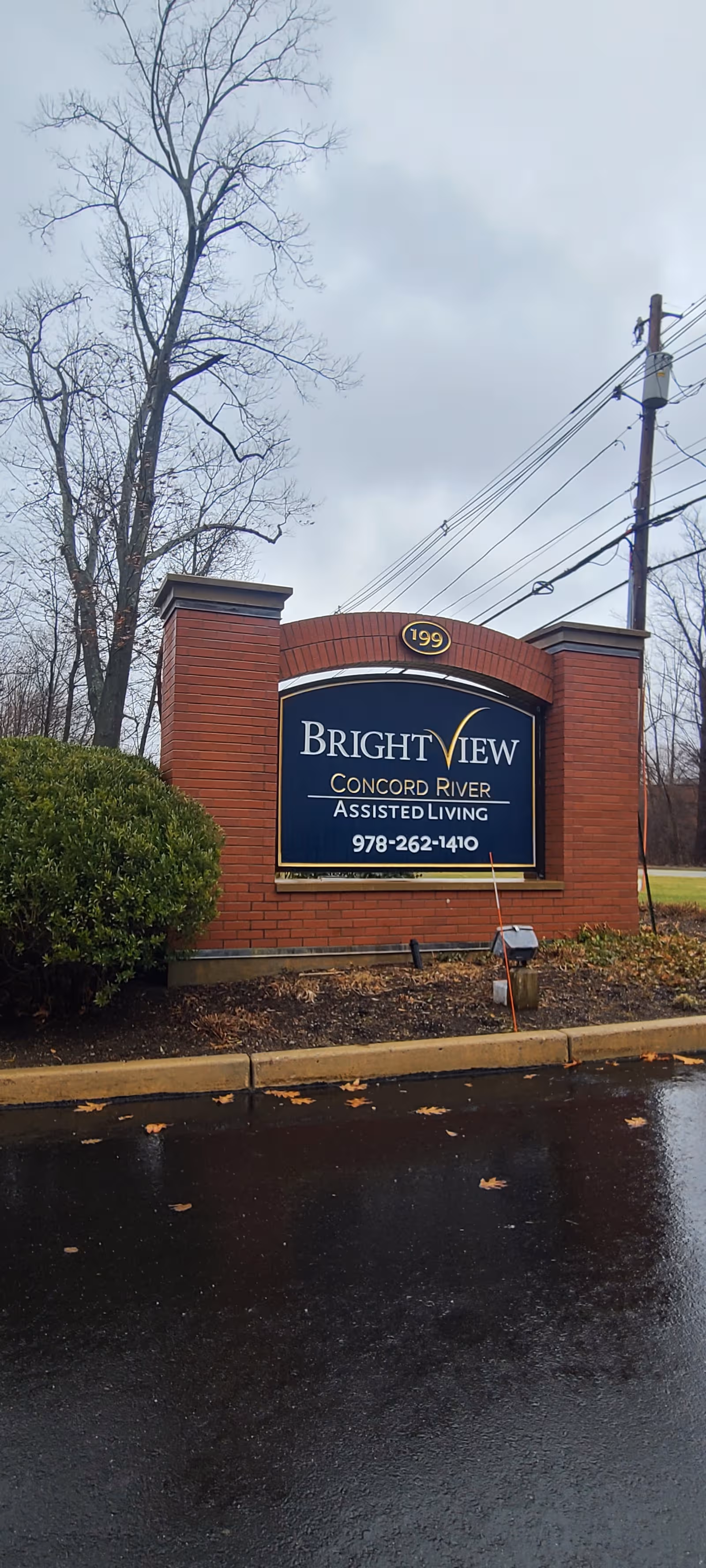 Brick signage for BrightView Concord River Assisted Living at the building entrance.