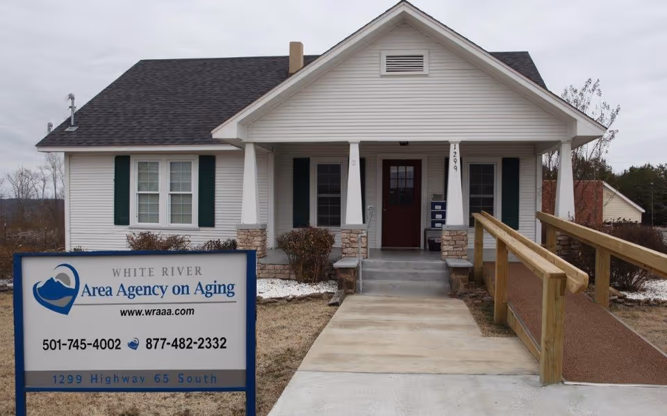 White, single-story building with a ramp and a sign for White River Area Agency on Aging.