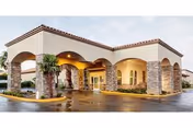 Exterior view of Red Cliffs Health and Rehab building with arches and stone columns.