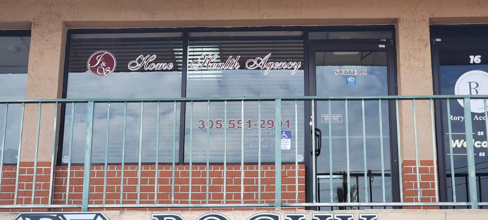Exterior storefront for I & S Home Health Agency with brick lower wall and railing