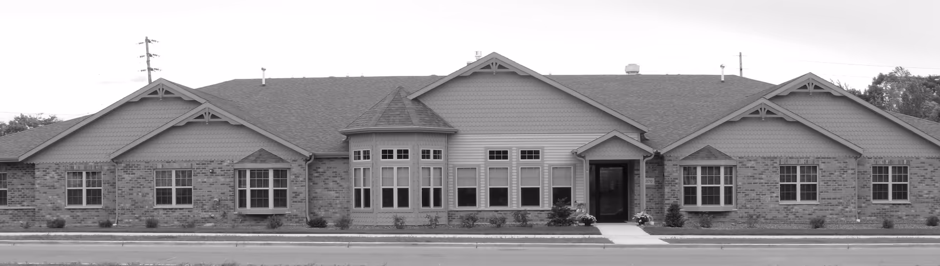 The front view of Ivy Manor of West Bend, a brick senior living facility.