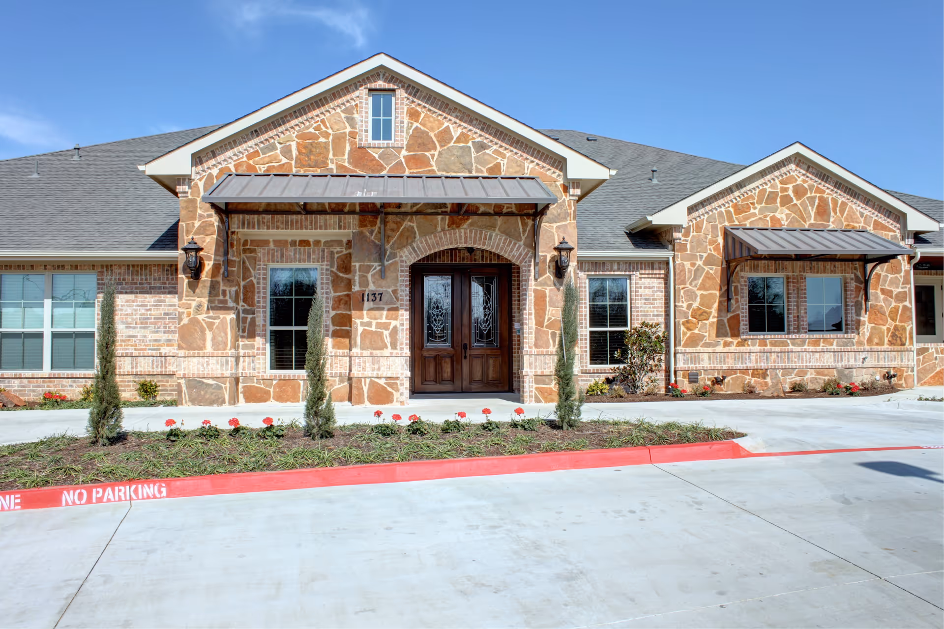 Front exterior of Avalon Memory Care Keller II with stone facade and landscaped entrance.
