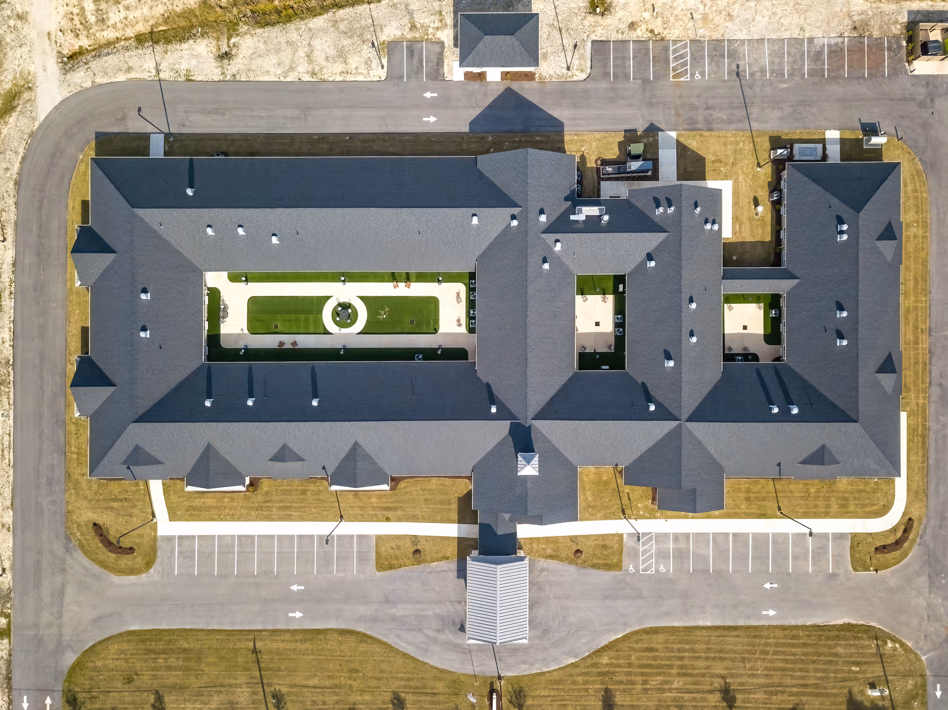 Aerial view of The Landings of Swansboro, showing the large gray-roofed building and surrounding parking.