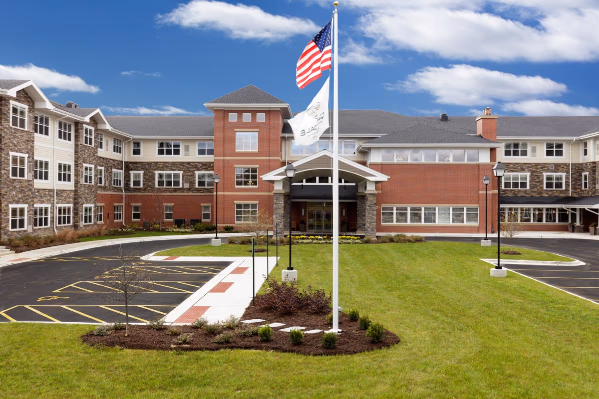 Exterior view of Clarendale of Algonquin building with flagpole, driveway, and green lawn.