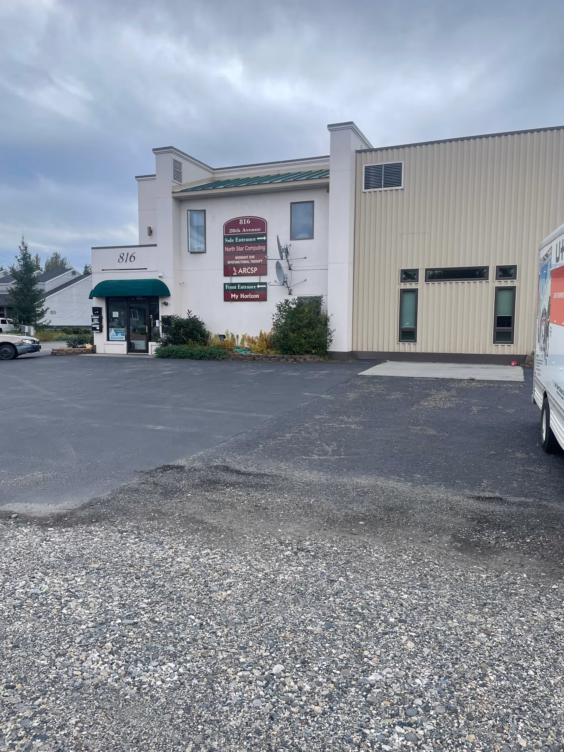Exterior view of TLC Care Services building with parking lot and entrance sign.